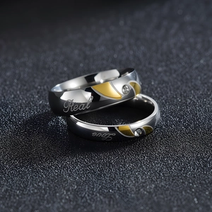 Polished silver and gold stainless steel couple rings with Real Love engraving and zircon