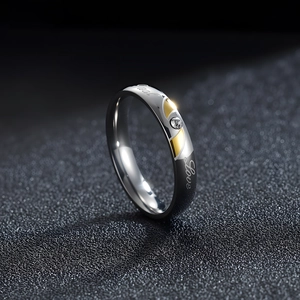 Polished titanium steel ring with Real Love engraving and gold accents for couples