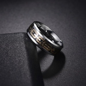 Detailed macro view of dual-tone stainless steel ring with golden chain texture