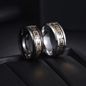 Macro detail of industrial chain rings with gold inlays in black and silver finishes