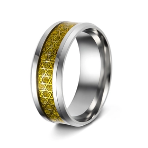 Macro detail of silver and gold stainless steel ring with engraved Star of David pattern