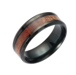 Detailed view of black titanium ring with natural acacia wood inlay and polished finish