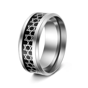 Macro view of polished silver steel ring featuring black enamel hexagram patterns