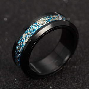 Macro detail of men's titanium ring with blue carbon fiber and silver dragon pattern inlay