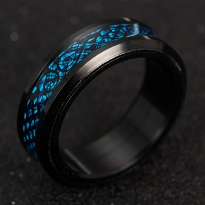 Macro shot of titanium steel men's ring with blue Celtic dragon inlay and beveled edges
