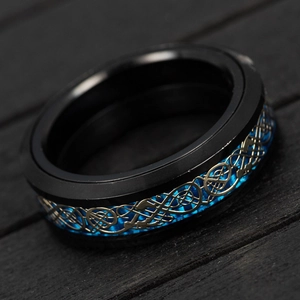 Detailed close-up of rotating black steel ring with blue carbon fiber and golden dragon pattern