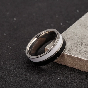 Macro shot of minimalist black and white spinning ring on grey stone texture background