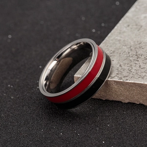 Detail of three-in-one spinning steel ring with red and black enamel on stone base