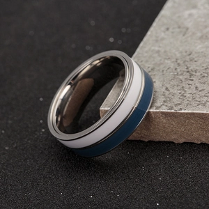 Detail of two-tone rotatable spinner ring in blue and silver titanium steel