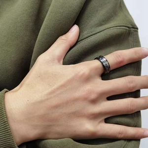 Men's 8mm black titanium ring with silver camouflage inlay on a model's hand