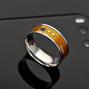 Macro shot of polished smart ring with orange circuit pattern and metallic finish