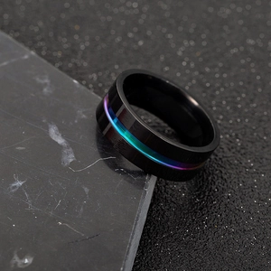 Macro shot of men's black brushed steel ring with rainbow gradient center groove