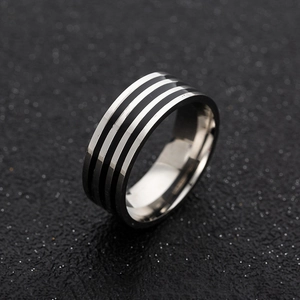Macro shot of 8mm wide men's stainless steel ring featuring three black enamel stripes