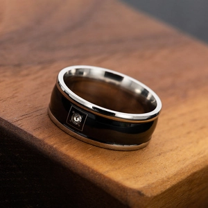 Polished stainless steel couple ring with black inlay and square set zircon on wood