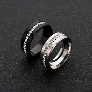 Detailed view of black and silver stainless steel rings with full channel set zircons