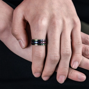 Men's black titanium steel ring with rainbow edges on hand for a modern style