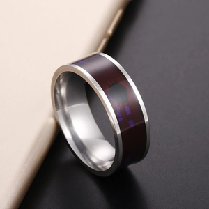 Macro view of the smart ring with red core and inner circuit patterns on a phone edge