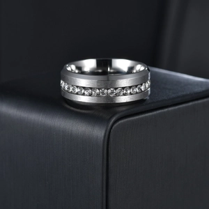 Macro detail of 8mm brushed stainless steel ring with a full row of clear zircon inlay