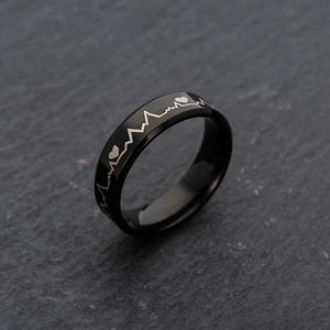 Detail shot of black stainless steel ring featuring 6mm ECG heartbeat and heart engraving
