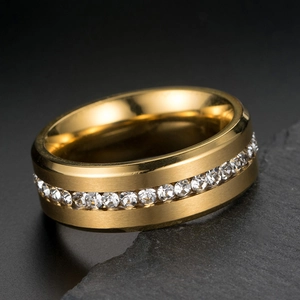 Close-up of a wide 8mm gold-plated ring with a full row of sparkling cubic zirconia
