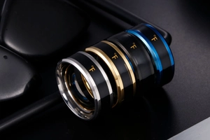 Macro view of four temperature sensing rings in silver, gold, black and blue stainless steel
