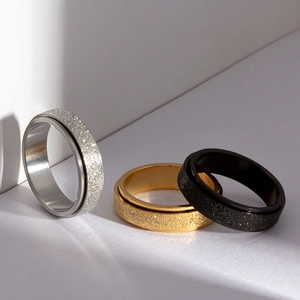 Three-piece stainless steel spinner ring set with glitter finish in silver gold and black