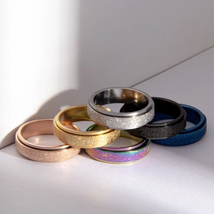 Frosted spinner rings in six colors showing rotatable stainless steel texture for anxiety relief