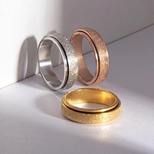 Three-piece set of matte spinner rings in silver, rose gold, and gold titanium steel