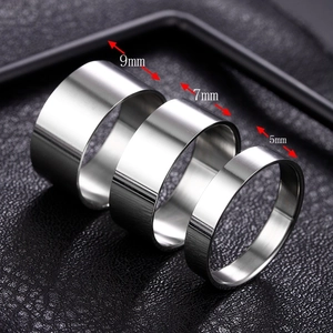 Three brushed stainless steel band rings in 5mm, 7mm, and 9mm widths on black leather