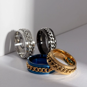 Titanium steel spinner rings with rotating chains in silver, black, blue, and gold finishes