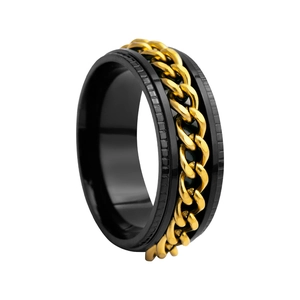 Close-up of men's black stainless steel spinner ring with a rotating gold curb chain