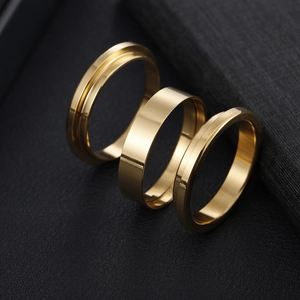 Three gold stainless steel DIY ring blanks with grooved and polished finishes