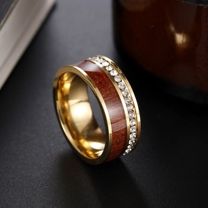 Macro view of luxury wood grain ring with inlaid cubic zirconia and gold edges