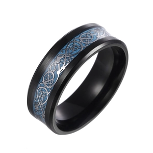 Detail of black stainless steel ring with blue carbon fiber inlay and silver dragon pattern