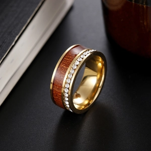 Close-up of gold ring with dark wood inlay and sparkling cubic zirconia row