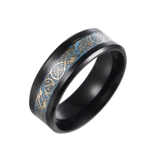 Macro detail of black stainless steel ring with blue inlay and golden dragon pattern