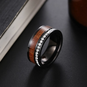 Macro detail of black ring featuring acacia wood inlay and a pavé row of cubic zirconia