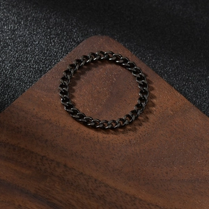 Industrial style black titanium steel Cuban link chain ring for women on wooden stand
