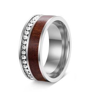 Macro detail of luxury silver ring with inlaid wood grain and micro-pave crystals