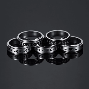 Five-piece spinner ring set in silver stainless steel featuring sun moon and star motifs