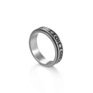 Detailed macro view of spinner ring featuring engraved sun, moon and star patterns
