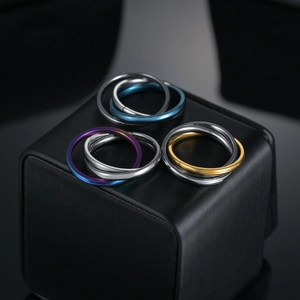 Three-band interlocking stainless steel rings in silver, blue, gold and rainbow finishes