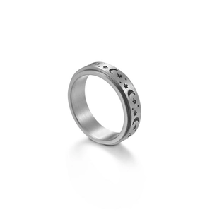 Detailed view of rotating spinner ring with moon and stars engraving on brushed steel