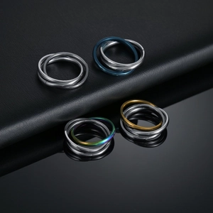 Modern triple interlocking stainless steel rings in silver, gold, blue, and rainbow finish