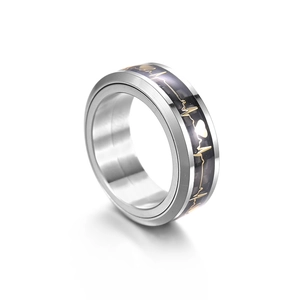 Detail of men's spinner ring featuring black carbon fiber inlay and gold ECG heartbeat line
