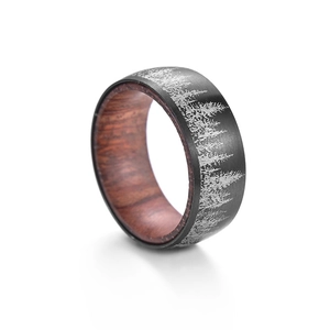 Brushed black steel ring with laser forest design and redwood interior lining