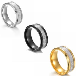 Close-up of wide titanium steel rings with meteorite texture inlay in silver, gold, and black