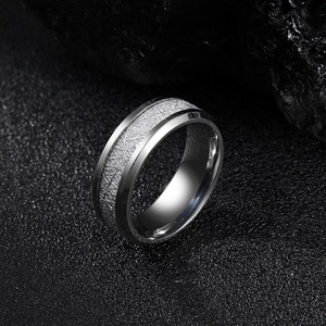 Mens silver titanium steel ring with ice foil inlay on black textured stone background