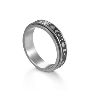 Rotatable stainless steel spinner ring featuring vintage sun, moon, and star relief patterns