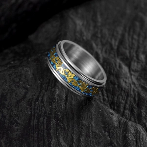 Detail of 8mm rotating stainless steel ring with blue carbon fiber and gold dragon inlay